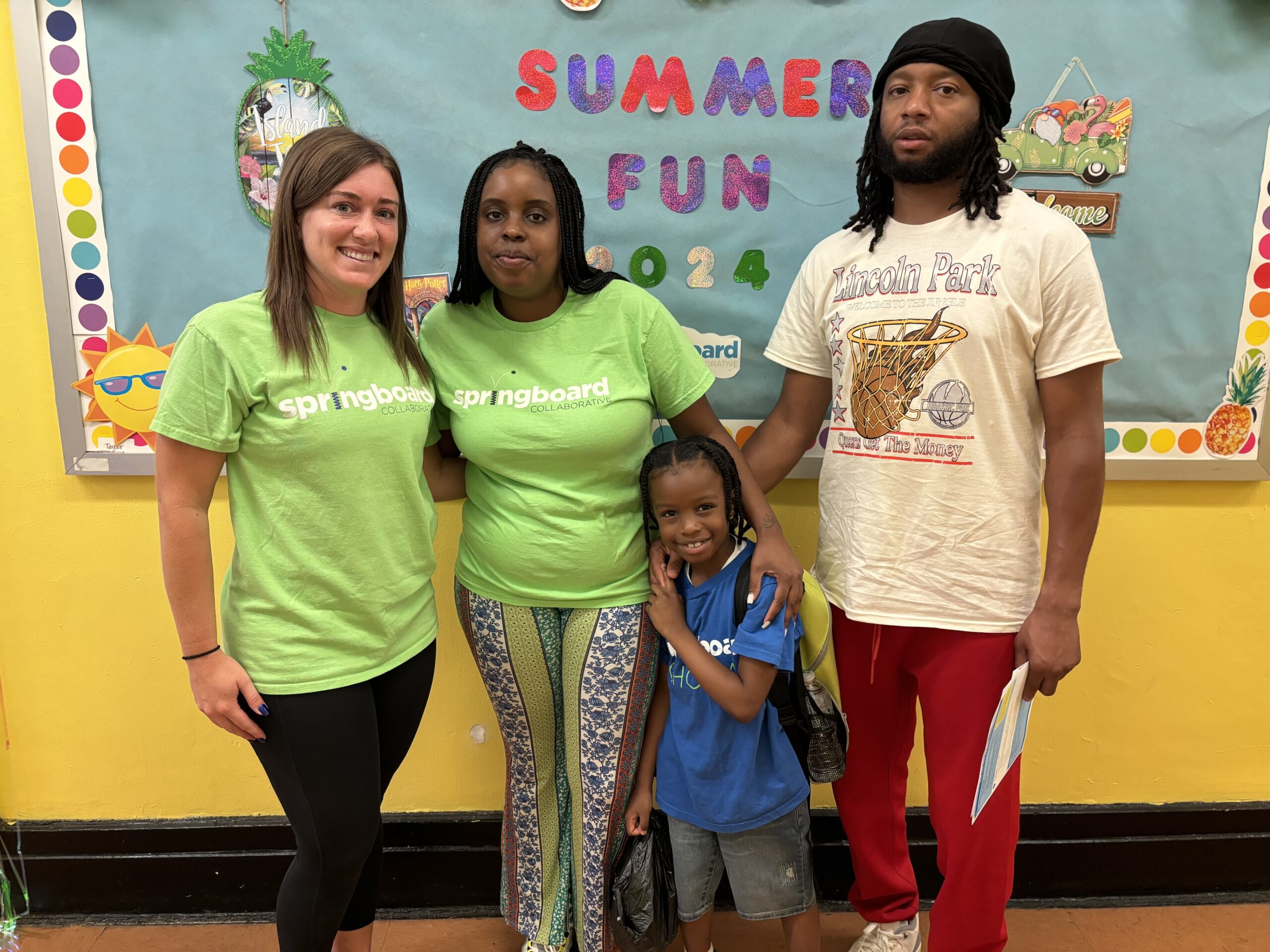 African American family with a female Caucasian teacher