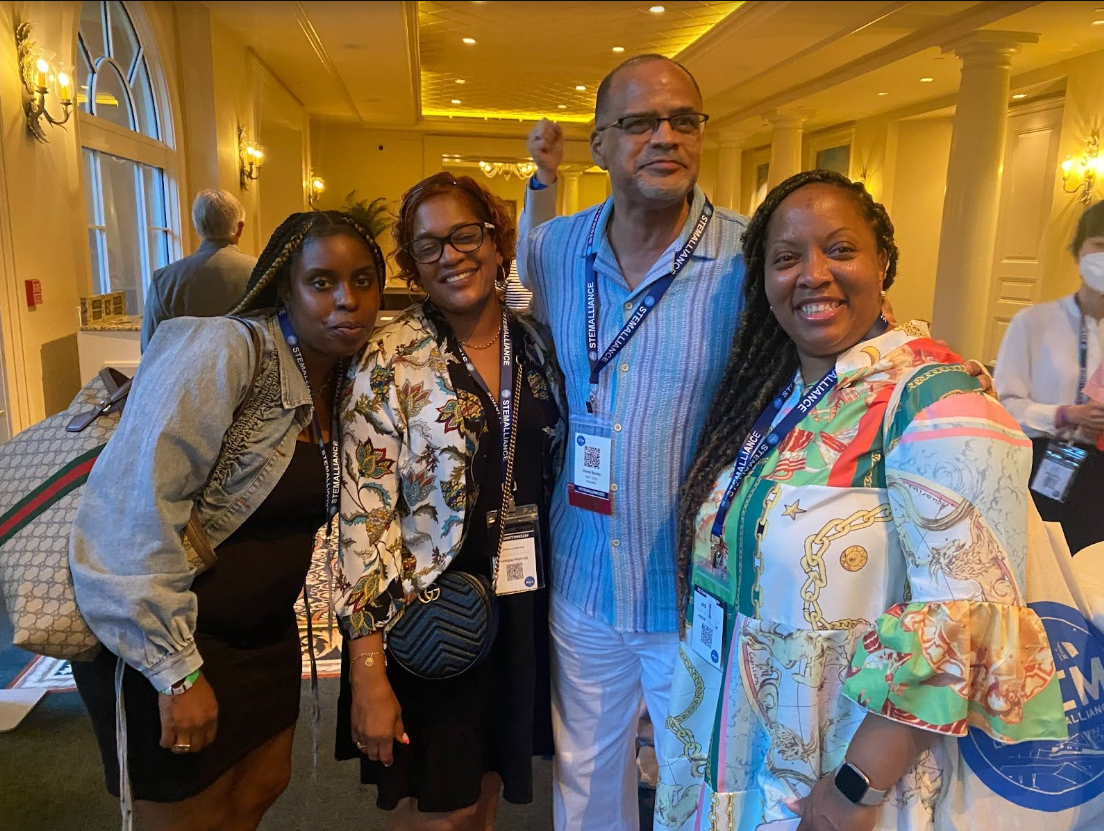3 African American women and 1 African American man in an embrace